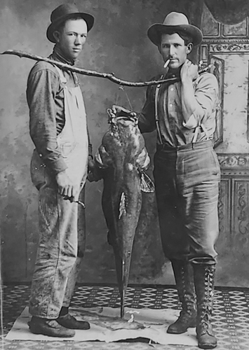 Two men with catfish